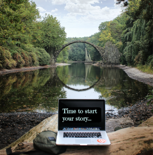 Computer in nature by lake and bridge with author Elizabeth Van Tassel
