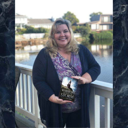 Author Elizabeth Van Tassel holding Warriors Against The Storm Anthology